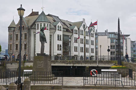 Alesund, Norway - June 03, 2010: View to the Fisher Boy statue with old building at the background in Alesund, Norway.のeditorial素材
