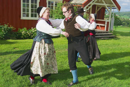 Roli, Norway, June 25, 2013 - People wearing historical costumes perform traditional dance in Roli, Norway.のeditorial素材