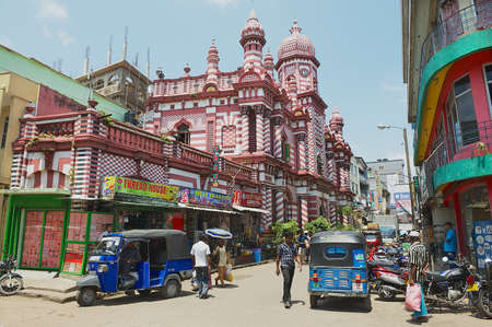 Colombo, Sri Lanka, May 17, 2011 - People walk by the street with colonial architecture building at the background in downtown Colombo, Sri Lanka.のeditorial素材