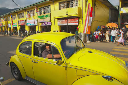 Kandy, Sri Lanka, May 21, 2011 - People in a vintage car pass by the street of Kandy, Sri Lanka.のeditorial素材