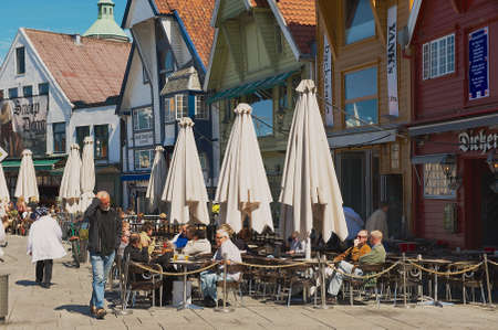 Stavanger, Norway, June 04, 2010 - People relax in a street cafe in downtown Stavanger, Norway. Stavanger city is often called "The Oil Capital of Norway".のeditorial素材