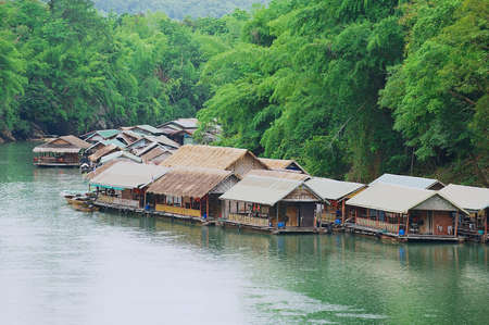Suphan Buri, Thailand - August 18, 2011: View to the traditional thai village at the river bank in...