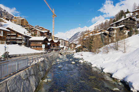 Zermatt, Switzerland - March 03, 2009: View to the river and traditional houses in Zermatt, Switzrland. Zermatt is one of the most popular ski resorts in Switzerland.のeditorial素材