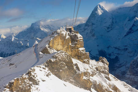 Murren, Switzerland - December 08, 2009: View to the Birg cable car station from the cable car gondola on the way to Schilthorn in Murren, Switzerland.のeditorial素材