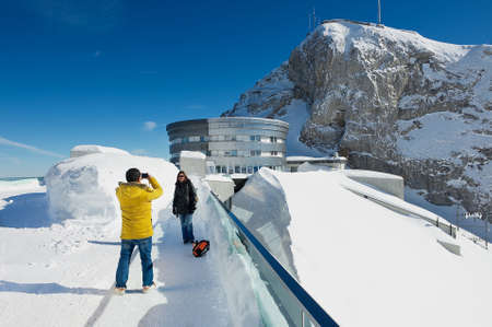 Lucern, Switzerland, February 21, 2012 - Tourists make travel photo at the terrace on top of the Pilatus mountain in Lucern, Switzerland.のeditorial素材