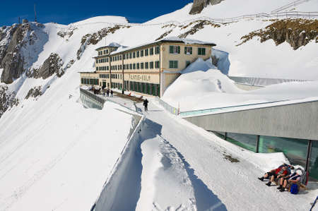 Lucern, Switzerland, February 21, 2012 - People sunbathe at the terrace of the Pilatus-Kulm luxury hotel at the top of the Pilatus mountain in Lucern, Switzerland.のeditorial素材