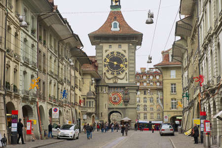 Bern, Switzerland, February 23, 2012 - People walk by the street with the historic Bern Clock tower at the background in Bern, Switzerland.のeditorial素材