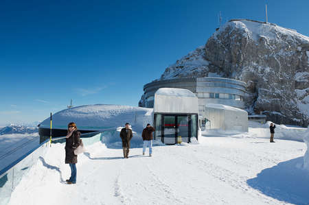 Lucern, Switzerland, February 21, 2012 - People enjoy the mountain view from the terrace on top of the Pilatus mountain in Lucern, Switzerland.のeditorial素材