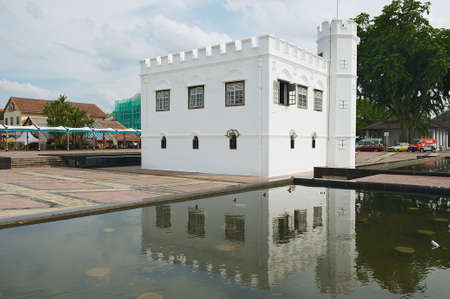 Kuching, Malaysia - August 26, 2009: Exterior of the white historical building reflected in the water of the pond in Kuching, Malaysia.のeditorial素材