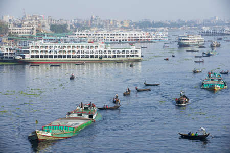 Dhaka, Bangladesh - February 21: Residents of Dhaka cross Buriganga river by boats in Dhaka,...