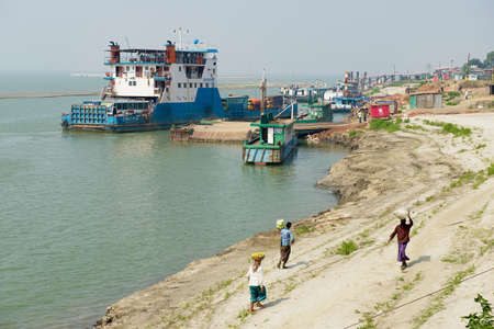 Chhota Dhulandi, Bangladesh - February 19, 2014: View to the ferry pier and river bank in Chhota...