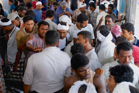 Al Hudaydah, Yemen, September 17, 2006 - Men bargain at the fish auction at the fish market in Al...
