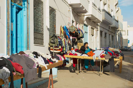 Sfax, Tunisia, November 30, 2011 - Woman sells secons hand goods at the street in the medina of Sfax, Tunisia.のeditorial素材
