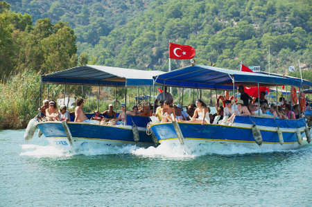 Mugla, Turkey, August 13, 2009 - Tourists enjoy river cruise by the Dalyan river in Mugla, Turkey.のeditorial素材
