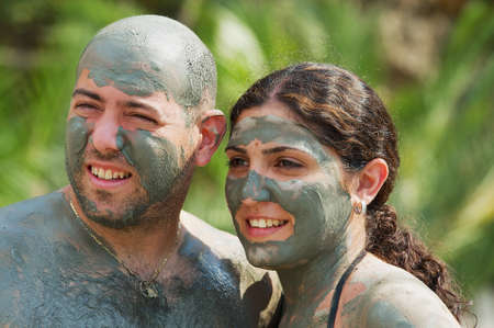 Dalyan, Turkey, August 13, 2009 - Couple pose for photo after taking mud bath in Dalyan, Turkey.のeditorial素材