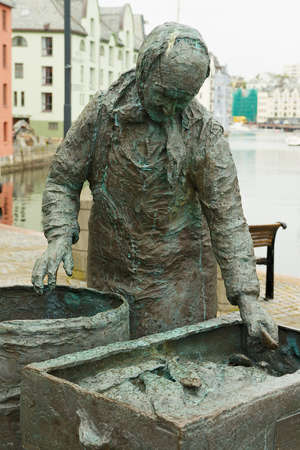 Alesund, Norway - June 03, 2010: Exterior of the Herring woman statue in Alesund, Norway. Fishing (especially herring) industry historically was very important for Alesund.のeditorial素材