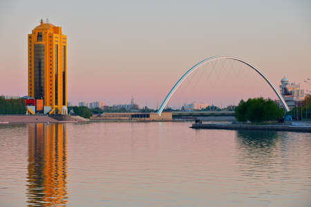 Astana, Kazakhstan - September 25, 2011: View to the city buildings and bridge over the Ishim river at dusk in Astana, Kazakhstan.のeditorial素材
