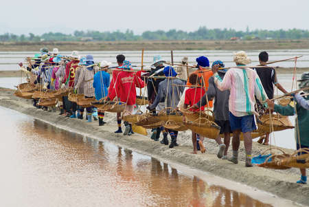Huahin, Thailand, May 13, 2008 - People work at the salt farm in Huahin, Thailand. Salt production is one of the main industries in the Huahin area, it brings modest income to many local families.のeditorial素材