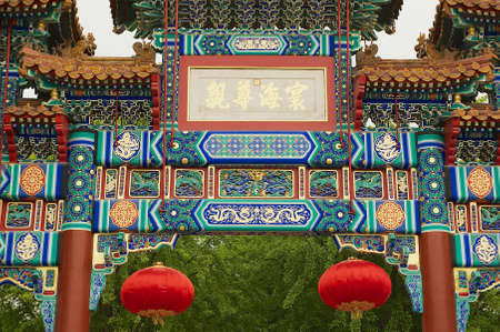 Beijing, China - May 01, 2009: Exterior detail of the colorful decorated entrance gate to the Yonghegong Lama Temple in Beijing, China.のeditorial素材