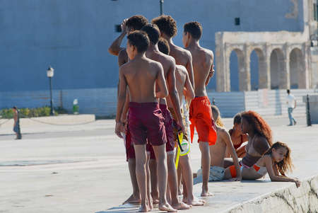 Havana, Cuba, October 21, 2006 - Teenagers sunbathe at the Malecon seawall in Havana, Cuba.のeditorial素材