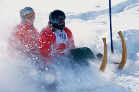 Grindelwald, Switzerland, March 07, 2009 - Men ride traditional horn-sledge at the 12th annual Horn-Sledge Race from Alpiglen to Grund in Grindelwald, Switzerland.のeditorial素材