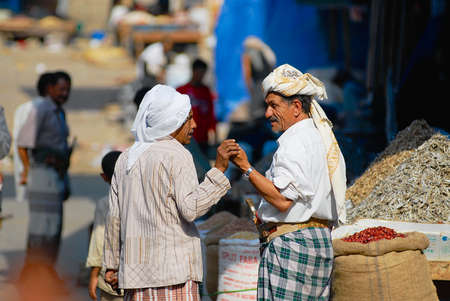 Sanaa, Yemen, September 18, 2006 - Two senior men talk at the street market in Sanaa, Yemen.
