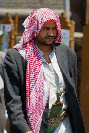 Sanaa, Yemen, September 18, 2006 - Yemeni man wears janbiya dagger at a street in Sanaa, Yemen. Janbiya is a traditional dagger and a mandatory attribute of Yemeni men's suit.のeditorial素材