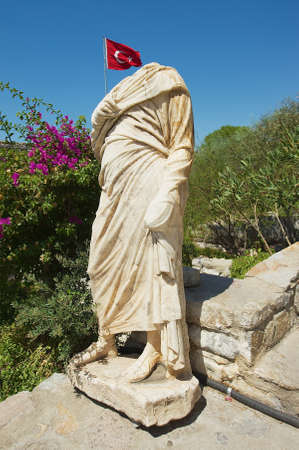 Ancient statue with Turkish National flag at the background in Bodrum, Turkey.の写真素材