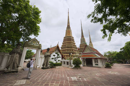 Bangkok, Thailand, May 30, 2009 - Tourist takes photo of the Wat Pho temple in Bangkok, Thailand.のeditorial素材