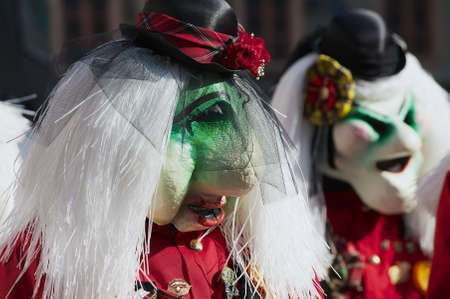 Lucerne, Switzerland, February 20, 2012 - Pseople wearing masks take part in the parade during carnival in Lucerne, Switzerland.のeditorial素材