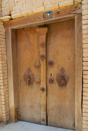 Yazd, Iran - June 17, 2007: Exterior of the house with the vintage men's and women's door handles in Yazd, Iran.のeditorial素材