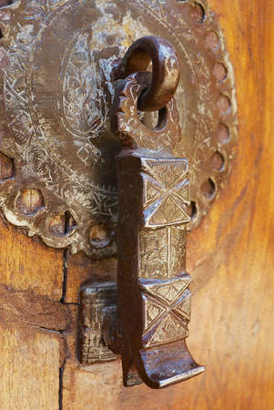 Shiraz, Iran - June 20, 2007: Vintage metal door at an old house in Shiraz, Iran. Door handles of...