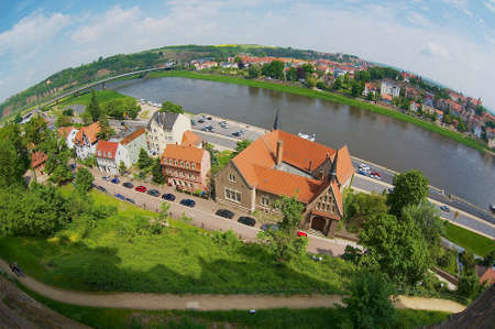 Meissen, Germany - May 22, 2010: View to the historic buildings along the banks of the Elbe river in Meissen, Germany. Filmed with a fish-eye lans.のeditorial素材