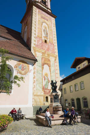 Mittenwald, Germany, September 01, 2010 - Tourists relax next to the statue of Matthias Klotz (the world famous violin maker) in Mittenwald, Germany.のeditorial素材