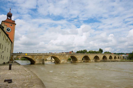 Regensburg, Germany - September 03, 2010: View to the medieval stone bridge across the Danube River in Regensburg, Germany.のeditorial素材