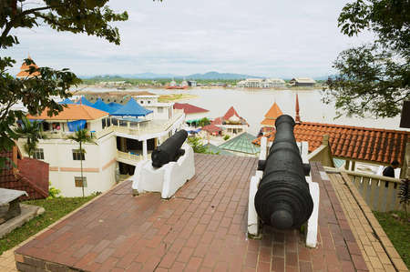 Kuala Terengganu, Malaysia - September 01, 2009: View to the harbor from the Princess hill with old canons at the foreground in Kuala Terengganu, Malaysia.のeditorial素材