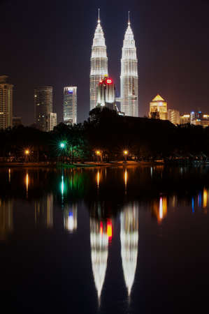 Kuala Lumpur, Malaysia - August 29, 2009: Skyline of Kuala Lumpur city at night with Petronas twin towers reflecting in the pond in Kuala Lumpur, Malaysia.のeditorial素材