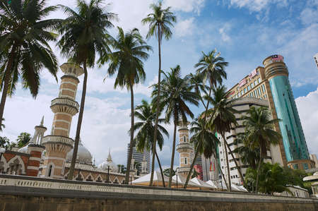 Kuala Lumpur, Malaysia - August 29, 2009: View to the Masjid Jamek Mosque with the modern buildings at the background in Kuala Lumpur, Malaysia.のeditorial素材