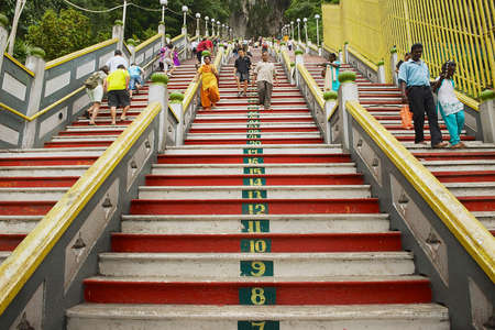 Kuala Lumpur, Malaysia, August 31, 2009 - People walk by the staircase leading to the Batu caves in Kuala Lumpur, Malaysia.のeditorial素材