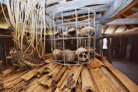 Kuching, Malaysia - August 27, 2009: Human sculls in the cage in the Headhouse of Annah Rais Bidayuh longhouse - the main building of the headhunters village in Kuching, Malaysia.のeditorial素材