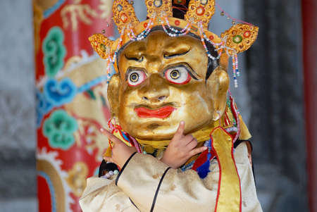 Ulaanbaatar, Mongolia, August 16, 2006 - Man demonstrates traditional shaman's mask and costume in...