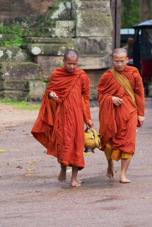 Siem Reap, Cambodia, August 08, 2008 - Monks walk by the road in front of the Angkor Thom South gate in Siem Reap, Cambodia.のeditorial素材