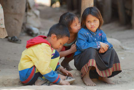 Luang Prabang, Laos, February 13, 2007 - Kids play at the street in a poor village near Luang Prabang, Laos.のeditorial素材