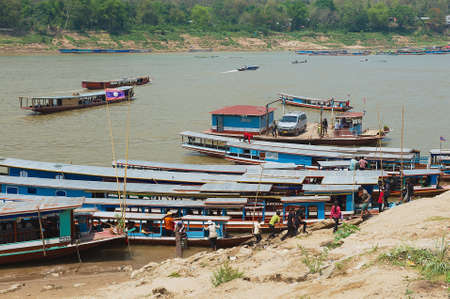 LUANG PRABANG, LAOS - APRIL 13, 2012: View to the local ferry boarding point at the Mekong river bank in Luang Prabang, Laos.のeditorial素材