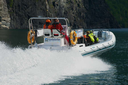 FLAM, NORWAY - JUNE 08,2012: Tourists enjoy the safari tour by speed boat at the Aurlandsfjord in Flam, Norway.のeditorial素材