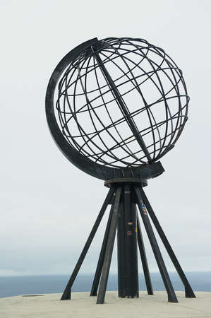 NORTH CAPE, NORWAY - SEPTEMBER 05, 2011: The symbolic globe at the North Cape point in a cloudy weather day in North Cape, Norway.のeditorial素材