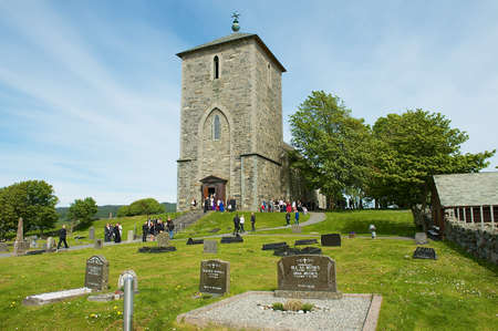 Kamroy, Norway - June 05, 2010: People visit St. Petersburg Olav's Church at Avaldsnes in Kamroy,...