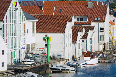 Haugesund, Norway - June 05, 2010: Traditional white painted wooden buildings at the riverside in Haugesund, Norway.のeditorial素材