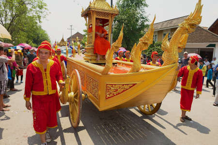 Luang Prabang, Laos - April 16, 2012: Monks take part in the religious procession from the Royal Palace to the Wat Mai Buddhist temple during Lao New Year celebration in Luang Prabang, Laos.のeditorial素材