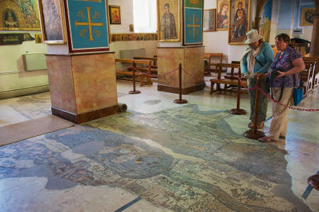Madaba, Jordan - August 18, 2012: Tourists visit  Byzantine Orthodox Basilica of St George with the mosaic map of Holy Land in Madaba, Jordan.のeditorial素材